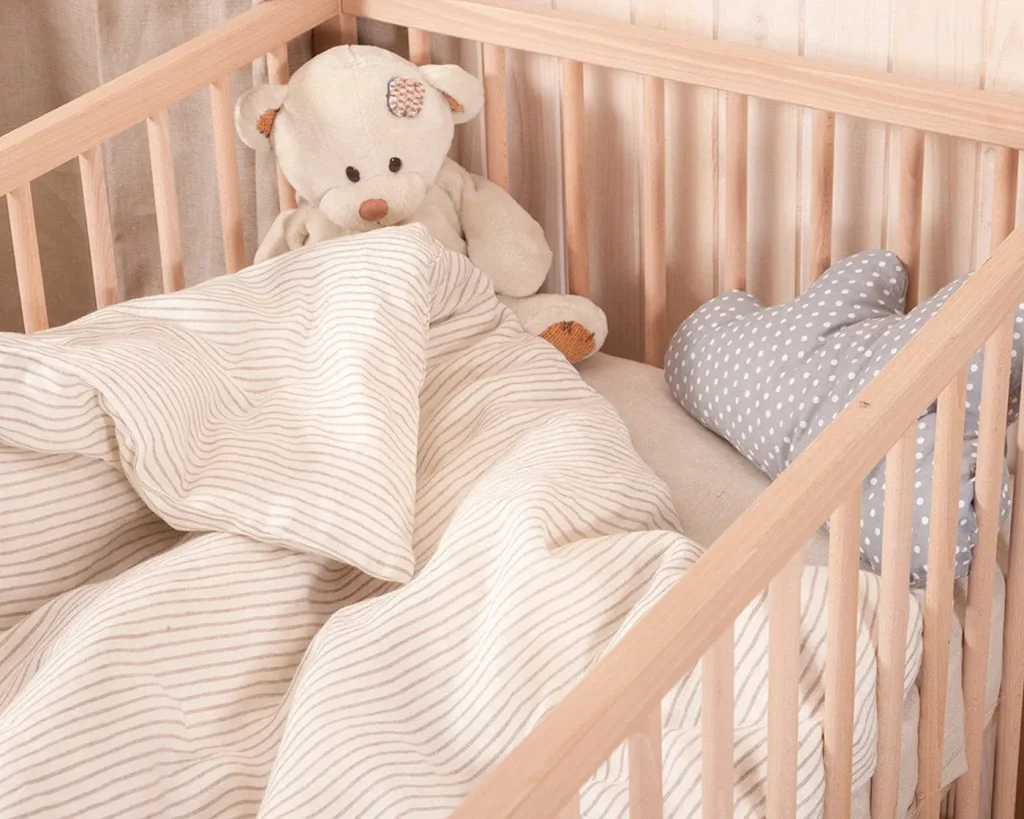 teddy bear in a child crib