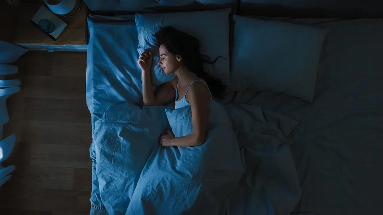 woman laying in bed on her side