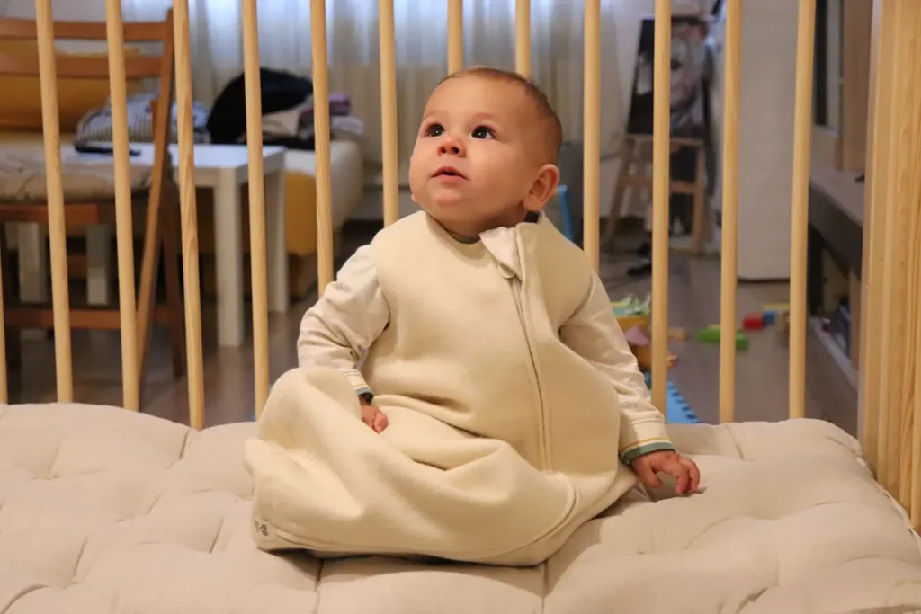 baby in a baby crib on a baby mattress