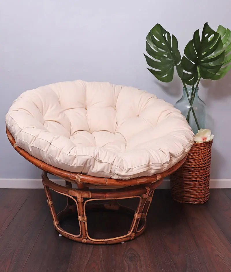 papasan chair with a home of wool papasan chair cushion next to a plant in a vase