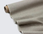 linen fabric being rolled out from a roll